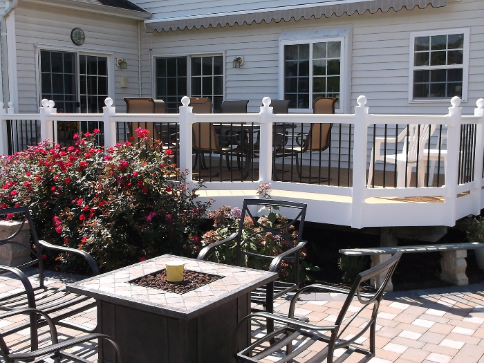 Backyard deck with black round pickets and patio