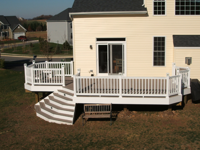 Backyard brown deck with lights and bench