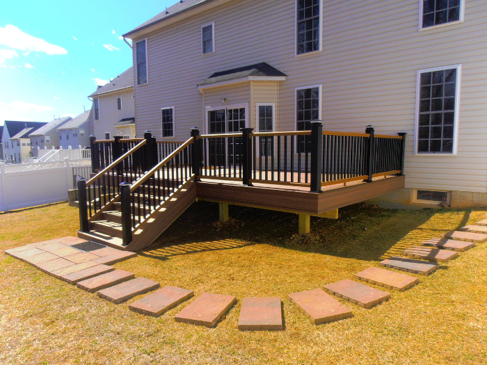 Black railing with lights on wood deck with matching fascia