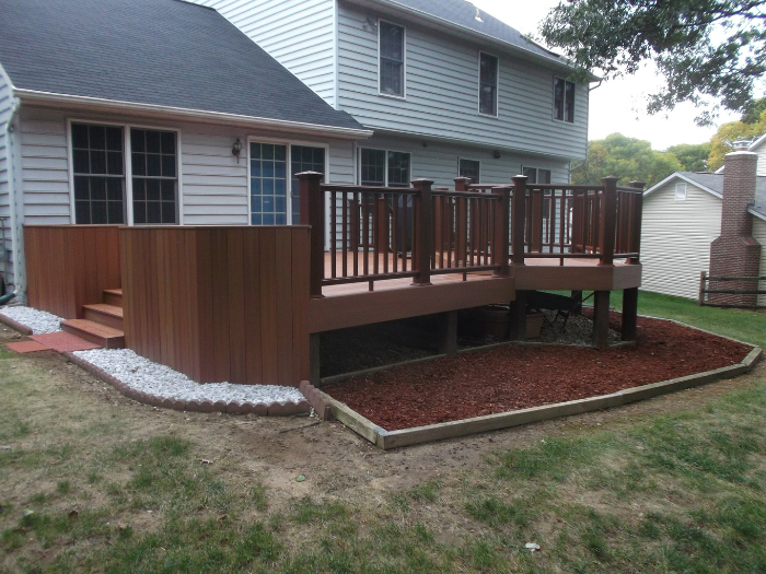 Brown deck with bronze railing and privacy panels