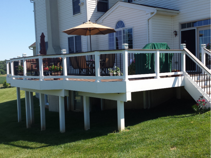 Brown deck with drink rail and deck lights daytime