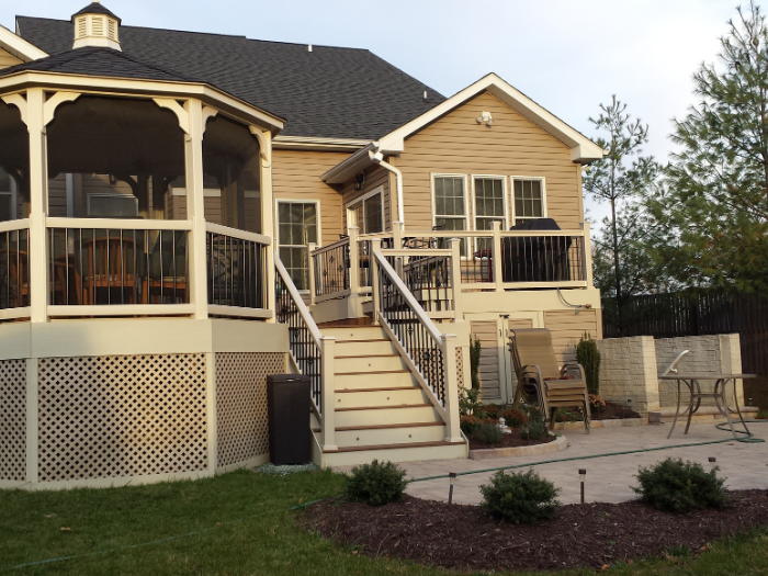 Brown deck with patio landing lights and decorative spindles