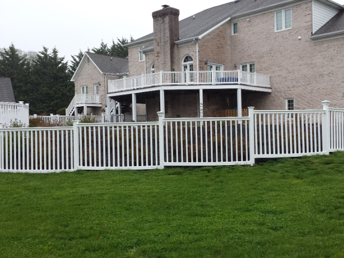 White Hampton fence with decorative light post caps