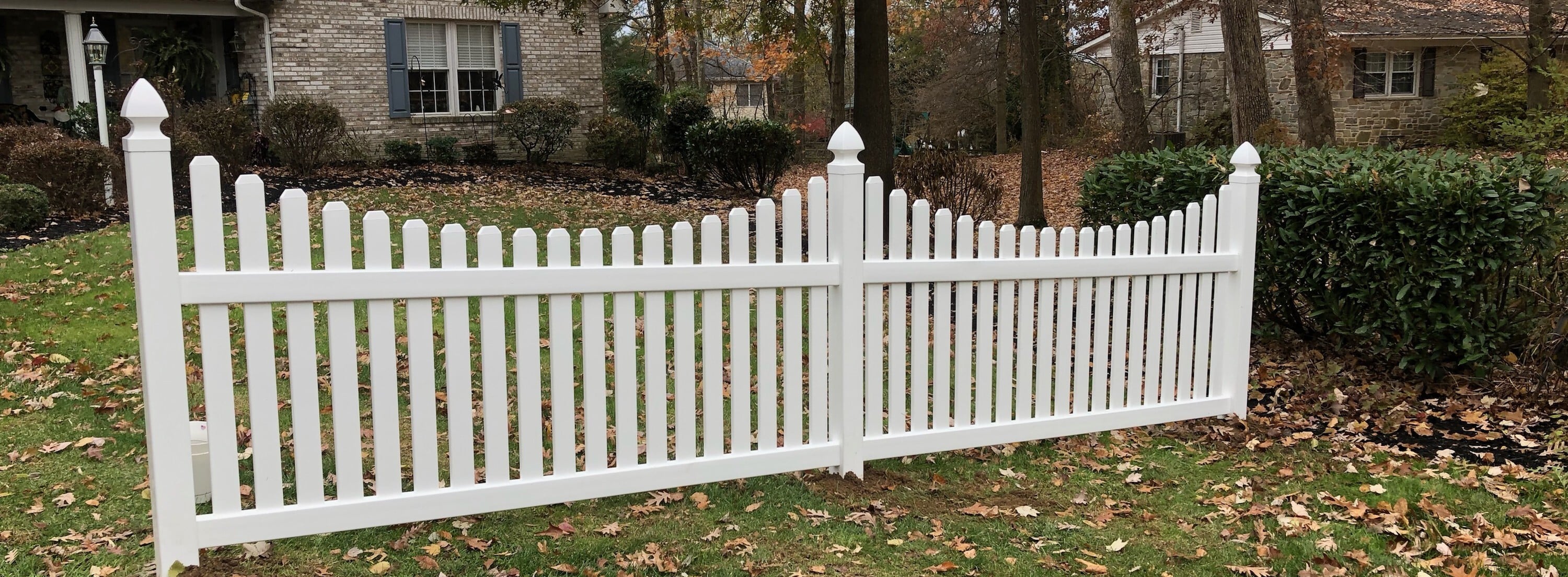 White vinyl scalloped picket fence installed by Creative Vinyl Products